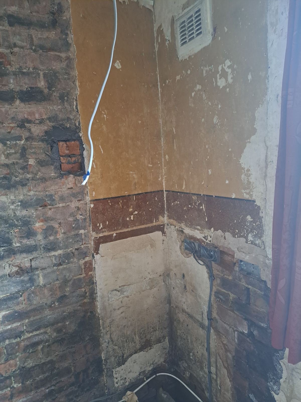 Before: chimney breast removed, bare brick and old plaster